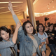 An unidentified Thai student flashes a three-finger salute as she is escorted out of a movie theater by plainclothes police officers in Bangkok, Thailand on November 20, 2014.